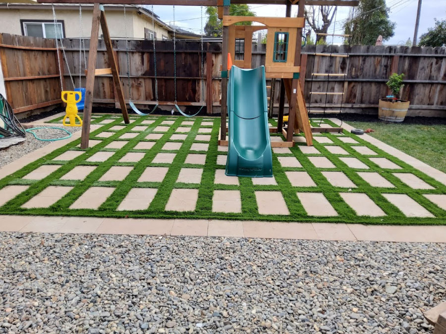 Use artificial turf to beautify a backyard playground with very low maintenance.